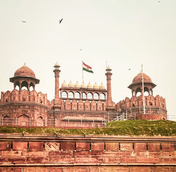 Historic Red Fort in New Delhi showcasing stunning Mughal architecture and the Indian flag.