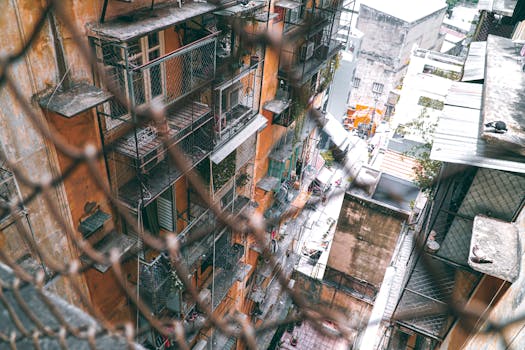 High angle view of an urban residential building with scaffolding and netting.